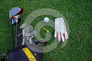 Golf glove , white golf ball and tee put on green grass of golf course ,This golf objects for play