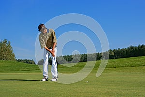 Golf, Golfer thrusting the ball into the hole