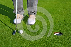 Golf green hole course man putting short ball
