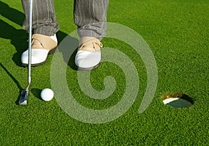 Golf green hole course man putting short ball photo