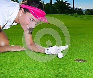 Golf green hole woman humor flicking hand a ball