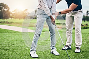 Golf lesson, sports teaching and coach hands helping a man with swing and stroke outdoor. Lens flare, green course and