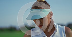 Golf player enjoy country club at green course. Woman golfer looking sunlight.