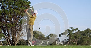 Golf player hitting the ball with his club