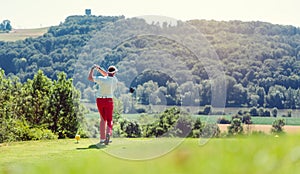 Golf player hitting ball long with driver