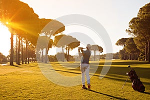 Golf player hitting shot with club