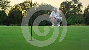 Golf player looking course on lush grass field. Golfer coach sit on fairway game