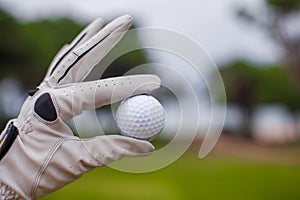 Golf player man holding golf-ball in his hand
