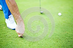 Golf player repairing divot