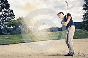 Golf player in sand trap.