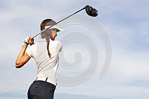 Golf player teeing off