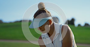 Golf player training course at country club. Sport woman hitting golfing ball.