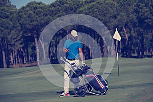 Golf player walking with wheel bag