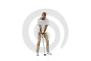 Golf player in a white shirt practicing, playing isolated on white studio background