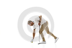 Golf player in a white shirt practicing, playing isolated on white studio background