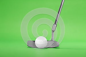 Golf Putter with Ball on a Green Background