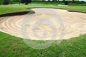 Golf: sand trap on the green grass