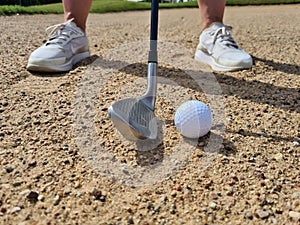 Golf shot from sand bunker golfer hitting ball from danger