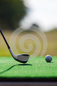 Golf Sport Concept : Ball and Golf club on artificial grass in golf driving range for training of golfer.