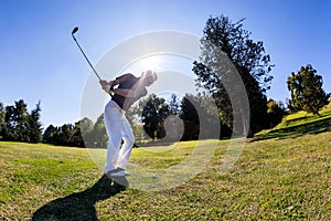 Golf sport: golfer hits a shoot from the fairway