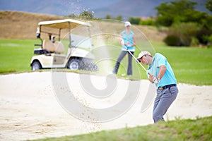 Golf, sports and man or golfer playing sport for fitness, workout and exercise with a swing on a green course. Wellness
