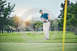 Golf, stroke and aim with a sports man swinging a club on a field or course for recreation, fun and hobby. Golfing