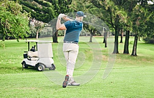 Golf, stroke and grass with a sports man swinging a club on a field or course for recreation and fun. Golfing, hobby and