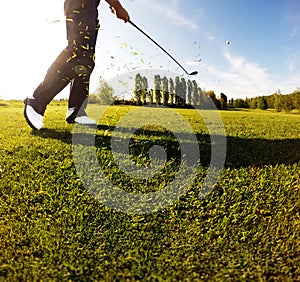 Golf swing on the course. Golfer performs a golf shot from the f