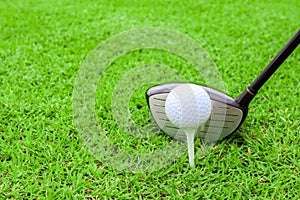 golf tee ball club driver in green grass course preparing to shot photo