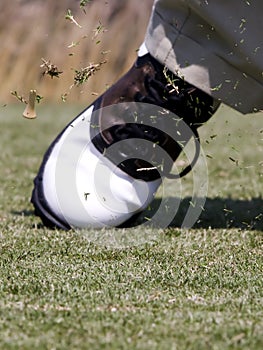 Golf tee flying after impact