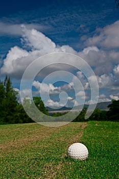 Golfball on course and blue sky