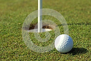 Golfball in front of the hole