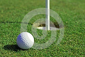 Golfball in front of the hole