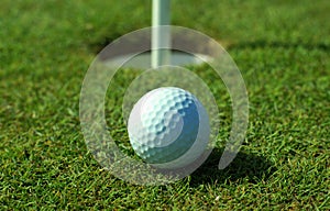 Golfball in front of the hole