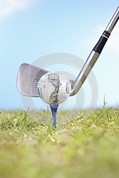 Golfball On Tee With Golf Club