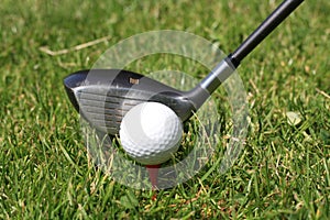 Golfball on tee and golfclub