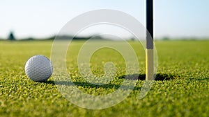 Golfed ball on golf course of green grass