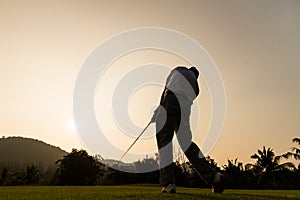 Golfer action while sunset