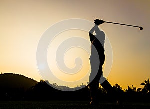 Golfer action while sunset