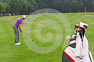 Golfer addressing the ball on a par 4 fairway.