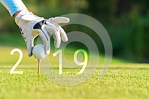 Golfer asian woman putting golf ball for Happy New Year 2019 on the green golf, copy space.