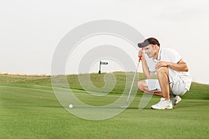 Golfer assessing his options to putt