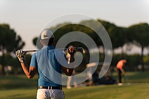 Golfer from back at course looking to hole in distance