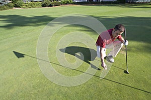 Golfer Bends to Mark Ball - Horizontal