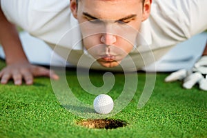 Golfer blowing in the ball