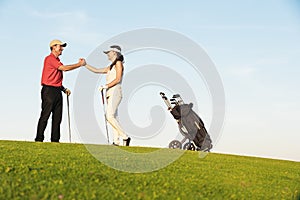 Golfer and Caddie playing golf.