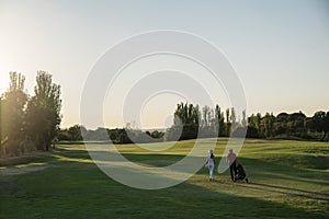 Golfer and Caddie playing golf.