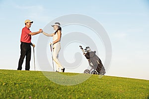 Golfer and Caddie playing golf. photo