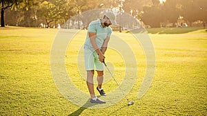 golfer in cap with golf club. people lifestyle. sport man playing game on green grass.