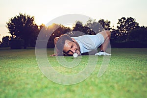 Golfer checking line of putt on green